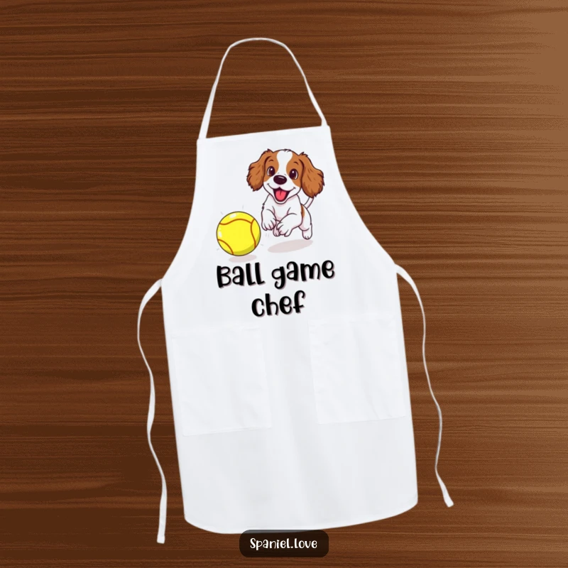 Funny spaniel puppy excitedly chasing a giant tennis ball, featured on a practical apron for kitchen fun.