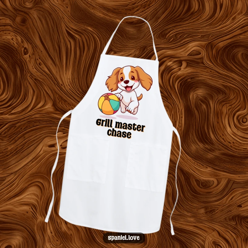 Funny apron featuring a spaniel dog with its ears flapping in the wind while joyfully chasing a colorful, bouncing ball in a kitchen setting.