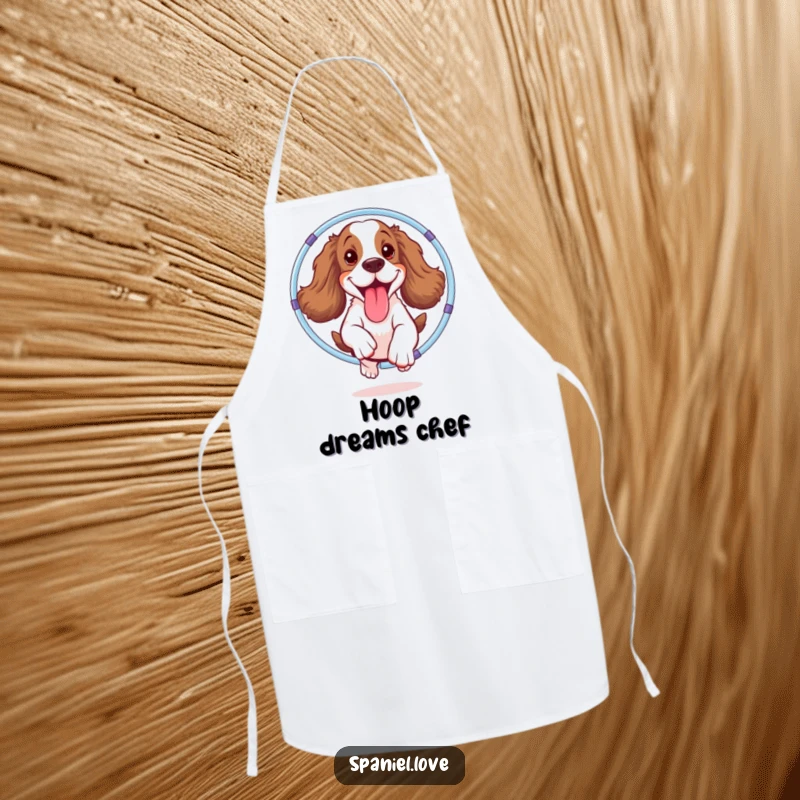 Funny spaniel apron showing a happy dog mid-hula hoop jump, tongue out, ready for kitchen fun with a side of humor.