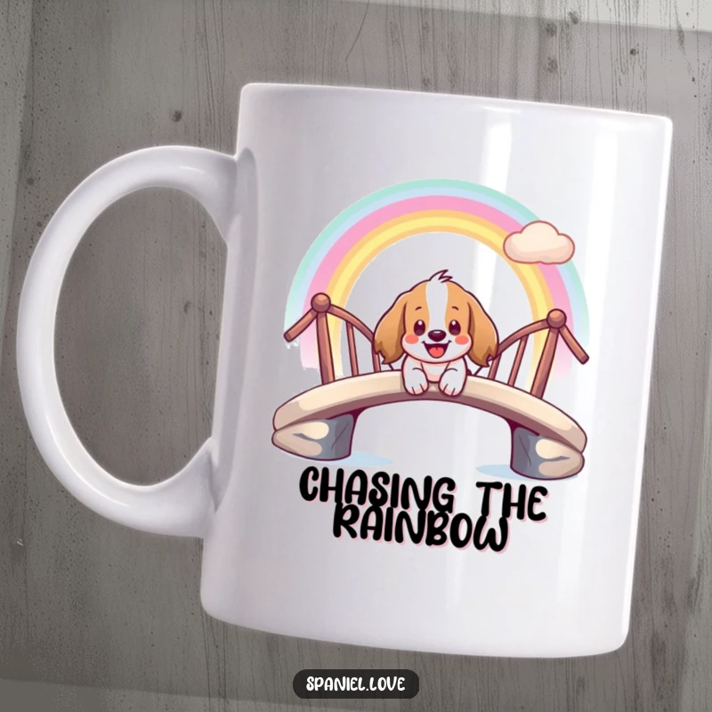 Funny mug showing a giddy spaniel character sliding joyfully down a vibrant rainbow bridge with a wide smile.