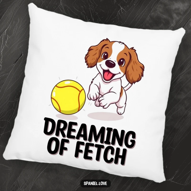 Funny spaniel puppy excitedly chasing an oversized tennis ball, presented on a plush pillow for comfort and playful vibes.