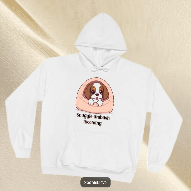 Funny spaniel character peeking from a dog bed with an expectant look, printed on a soft, warm hoodie.