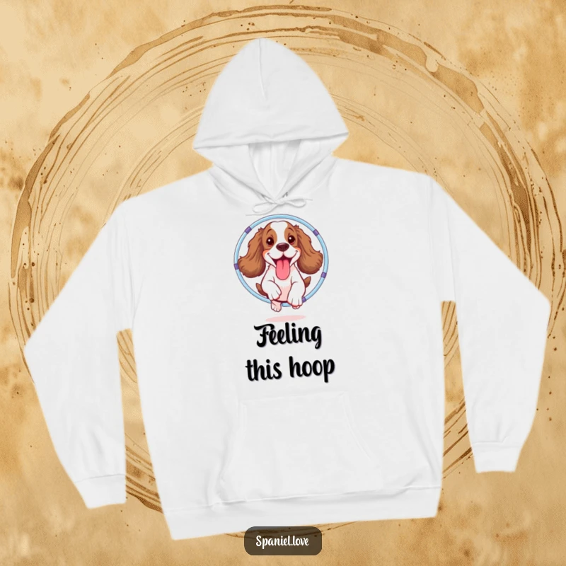 Funny spaniel hoodie featuring a happy dog with its tongue lolling out, energetically jumping through a hula hoop, embodying pure fun.