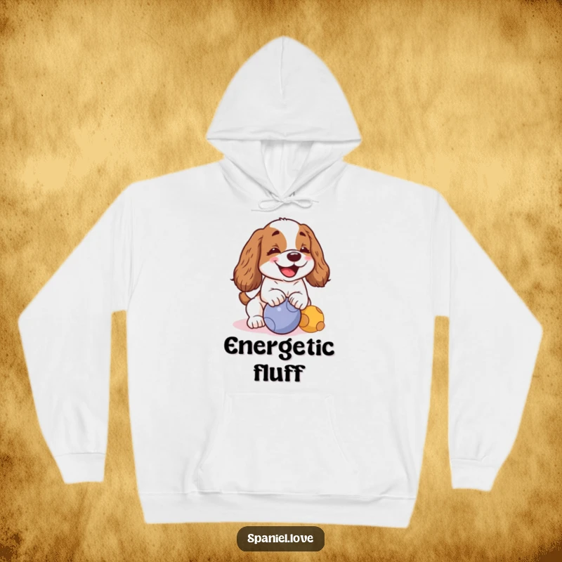 Funny kawaii spaniel with a cheerful bark, playfully nudging a ball on a hoodie, perfect for cozy, humorous wear.