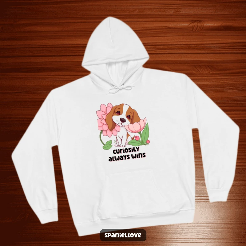 Funny hoodie showcasing a gentle spaniel dog with its head tilted curiously while sniffing a large, beautifully bloomed flower, looking intrigued.