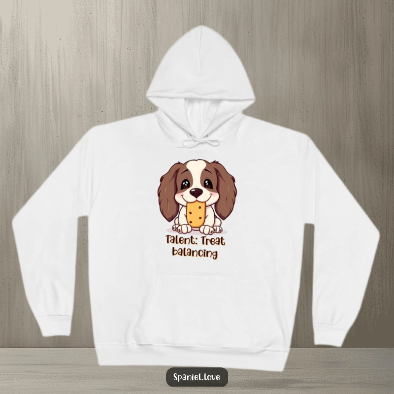 Funny Spaniel Hoodie: A spaniel with a goofy, silly grin is concentrated while balancing a treat on its nose.