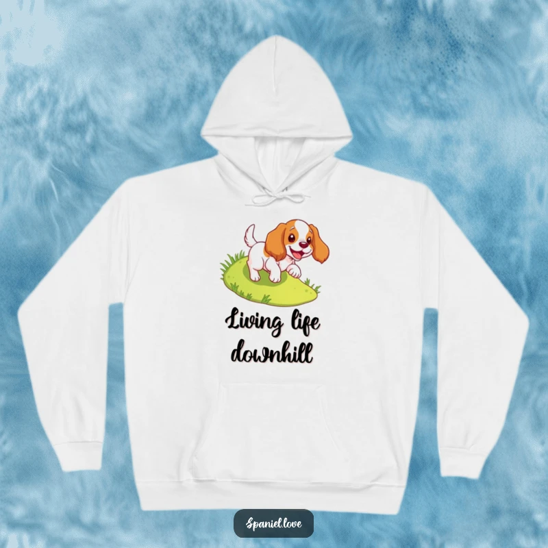 Funny spaniel hoodie featuring a dog joyfully tumbling down a slope, offering comfort and cheerful vibes.
