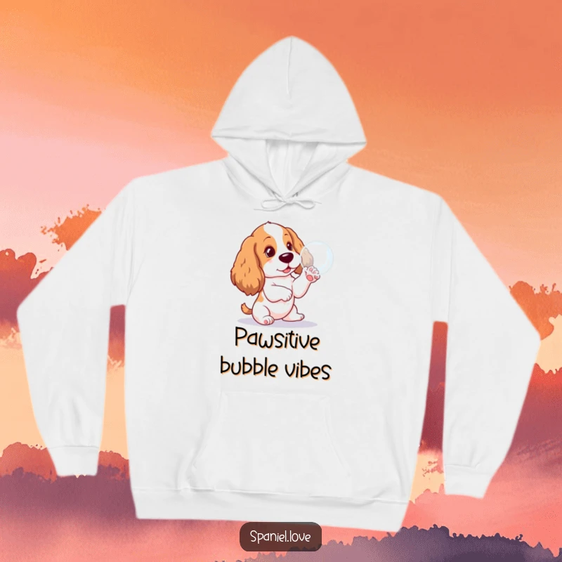 Funny Spaniel pup hoodie, caught in a moment of pure bliss pawing at a soap bubble, embodying playful innocence.