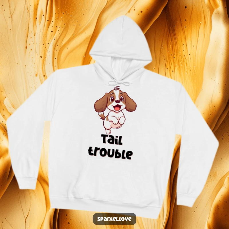 Funny hoodie illustrating a surprised spaniel character startled by its own vigorously wagging tail.