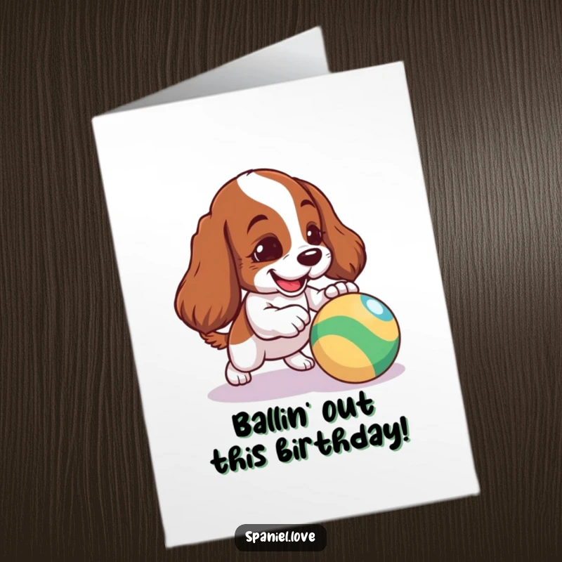 Funny Free Printable Birthday Card: Mischievous spaniel puppy playfully nudges a brightly colored bouncy ball, ready for fun.