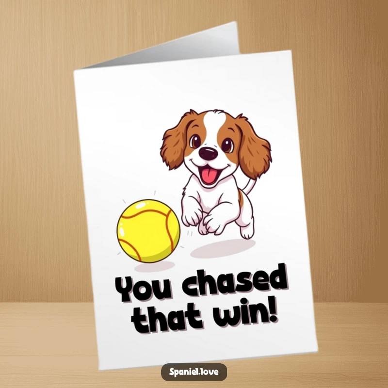 Funny free printable congratulations card: Spaniel puppy mid-leap, chasing an oversized tennis ball with intense, happy focus.