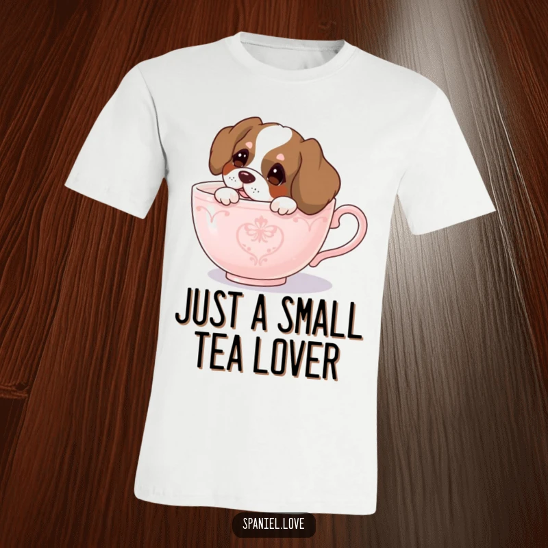 Funny spaniel t-shirt, a cute spaniel dog curiously peeking its head out from a large teacup, conveying playful wonder.