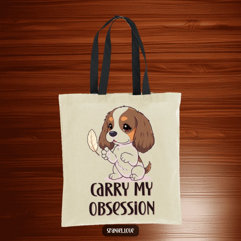 Funny spaniel tote bag showing tiny paws batting at a feather, perfect for carrying daily essentials with charm.